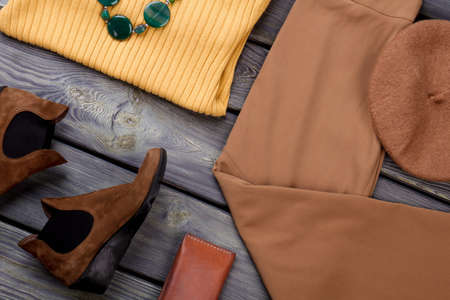 Close up collage of autumn womens cloth, flat lay. Grey wooden surface background.の写真素材