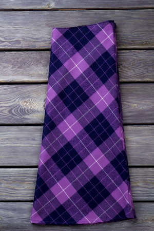Purple checkered skirt. Grey wooden surface background.の写真素材
