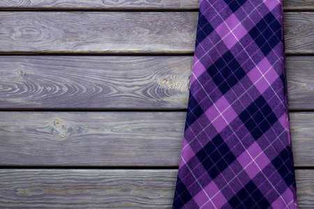 Flat lay violet winter skirt. Top view. Grey wooden surface background.の写真素材