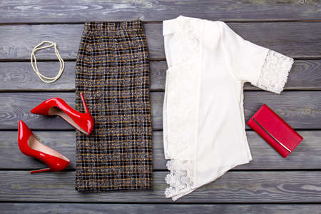 Flat lay woman autumn clothes set. Grey wooden desk surface background.の写真素材