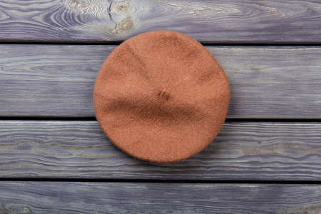 Top view beret hat. Top view, flat lay, wooden desk surface background.の写真素材