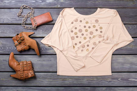 Collection collage of womens clothing and accessories. Top view, flat lay. Wooden desk surface background.の写真素材