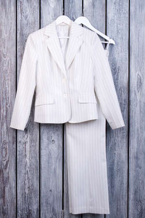 White business suit on hanger. Striped jacket and trousers, top view.の写真素材