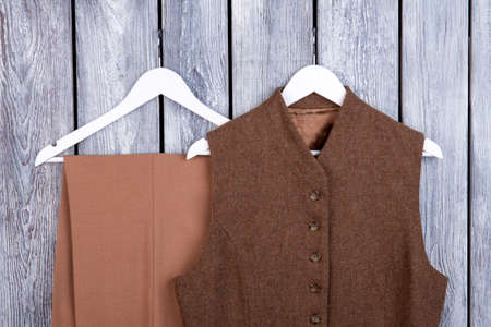 Vintage retro apparel on hangers. Top view, close up. Grey desk surface background.の写真素材