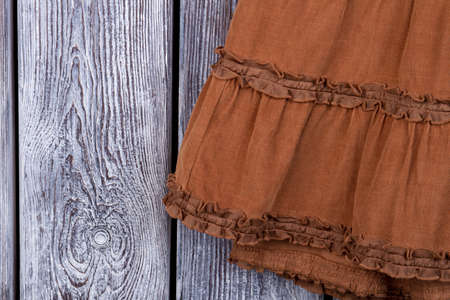 Close up brown skirt material. Grey desk surface background.の写真素材