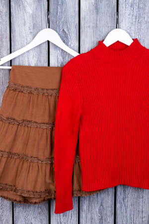 WInter female clothing on hangers. Grey desk surface background.の写真素材