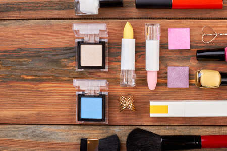 Decorative cosmetics wooden background. Flat lay of cosmetics set and tools, space for text. Women beauty desk.の写真素材