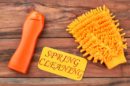 Equipment for cleaning on wooden background. Mitt for washing car. Organic detergent for cleaning. Make your car clean before spring.の写真素材