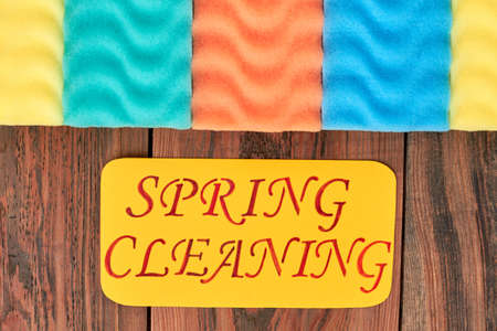Multicolored kitchens sponges and paper card. Row of colorful sponges for cleaning and paper message spring cleaning. How to clean your house quick.の写真素材