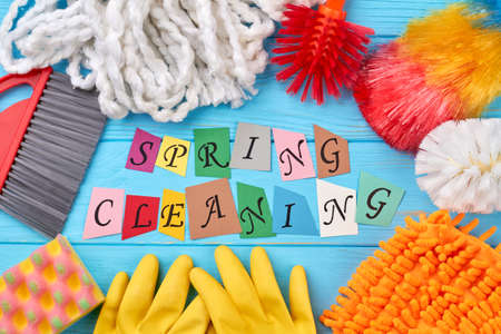 Set of cleaning products on colorful background. Spring cleaning concept with supplies on wooden table. Cleaning service in spring.の写真素材