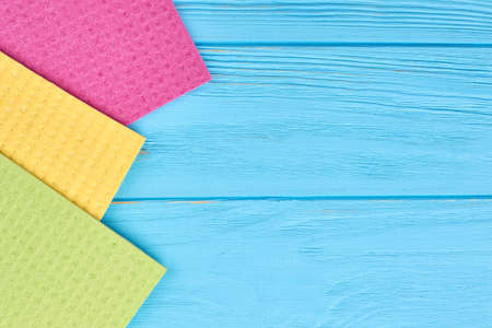 Kitchen cleaning napkin rags. Colorful kitchen cleaning cloth on blue wooden background, copy space.の写真素材