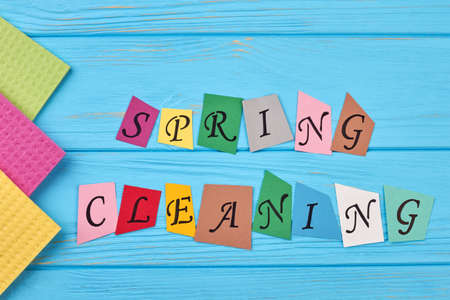 Text spring cleaning on wooden background. Kitchen cellulose napkins on blue wooden background. Time for spring clean up.の写真素材