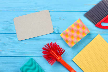 House cleaning products on wooden table. Empty cardboard card for text. Keep your house clean.の写真素材