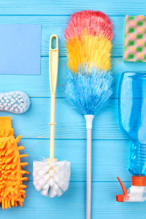 Set of cleaning equipment on a wooden background. Set of variety cleaning supplies on wooden table. Keep your home tidy.の写真素材