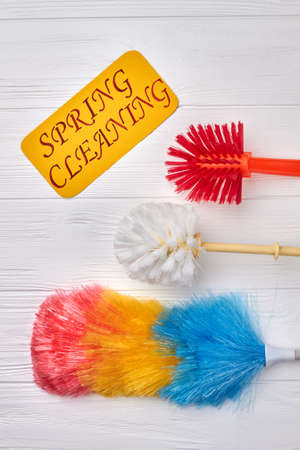 Spring cleaning concept with supplies. Set of brushes for cleaning on wooden background. Cleaning service products.の写真素材