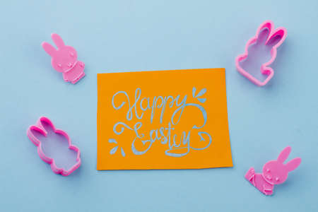 Silicone molds and Easter greeting card. Four rabbit shaped silicone molds and yellow Easter greeting card. Easter holidays handmade composition.の写真素材