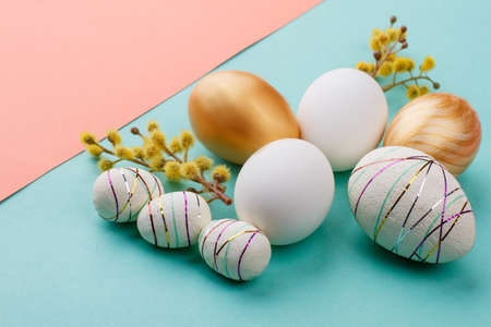 Still life Easter decoration. Close up modern Easter eggs and catkins on colorful background. Easter holidays art.の写真素材