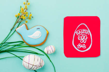 Spring Easter decoration and card. Beautiful Easter composition on blue background. Easter egg hunt concept.の写真素材