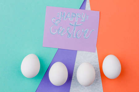 Happy Easter concept with eggs. Easter greeting card and white eggs on colorful background. Happy Easter holidays.の写真素材