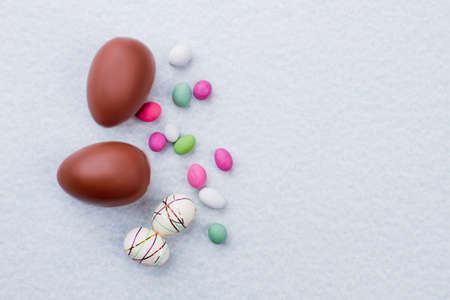 Chocolate easter eggs, sweets and copy space.