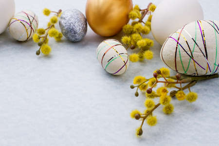 Easter background with pussy-willow and eggs. Easter decorative eggs and spring pussy willow on light blue background, copy space. Beautiful spring Easter composition.の写真素材