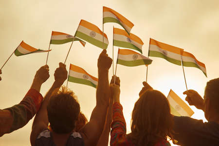 People holding small indian flags. Rally for human rights in India. Patriotic family outdoor....