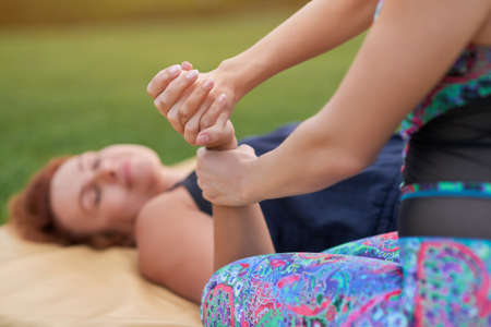 Hands thai massage and relaxing. Caucasian women practising thai massage.の写真素材