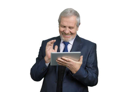 Cheerful smiling businessman with tablet device. Portrait of happy old senior man in business suit using portable computer device. White Isolated background.の写真素材