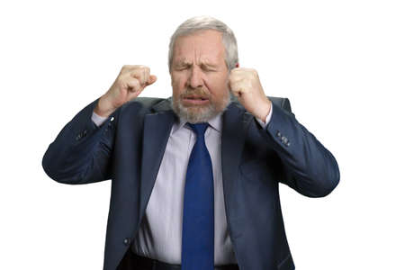 Mad crazy old man regrets awful mistake. Senior businessman made investment mistake. White isolated background.の写真素材