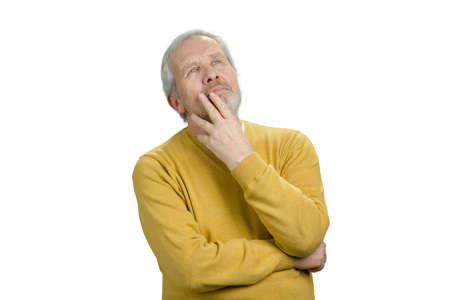 Old man thinking. Pensive grandpa in yellow woolen sweater. White isolated background.