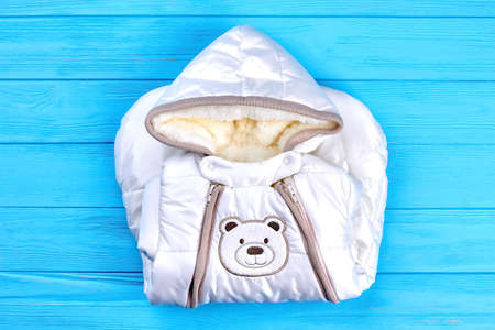 Baby-boy new winter romper. High quality folded warm winter romper for infant kids on blue wooden...
