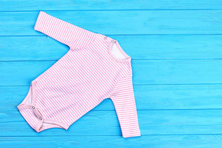 White pink striped baby bodysuit. Cotton long sleeve pink and white stripe one-piece bodysuit, copy space.の写真素材