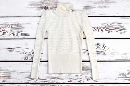 Boys or girls turtleneck sweater. Soft warm white knitted sweater for autumn or winter wardrobe.の写真素材