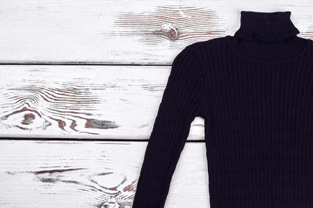 Cute turtleneck knitted black sweater. Warm winter knitwear and copy space. Texture design knitted sweater for boys.の写真素材