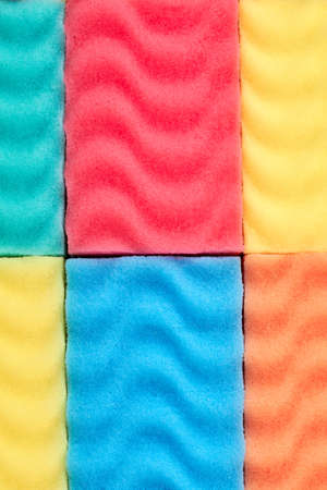 Close up of colorful kitchen sponges background. Multicolored kitchen sponges background. Detail of...