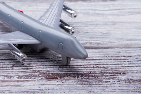 Toy airplane, extreme close up. Wooden desk surface background.