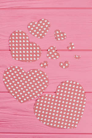 Wooden background with paper hearts, top view. Variety of colorful paper hearts for banner on wooden...