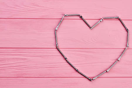 Shape of heart made from hardware. Valentines holiday background with heart shape made from metal fastener, copy space.の写真素材
