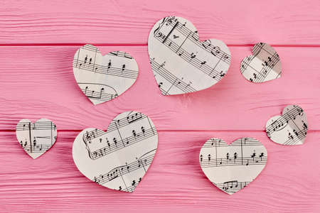 Valentines Day background with music notes. Set of white paper heart with musical notes on colorful...
