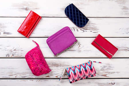 Collage from female bags and purses. Makeup bags on white wooden background. Set of women fashion...