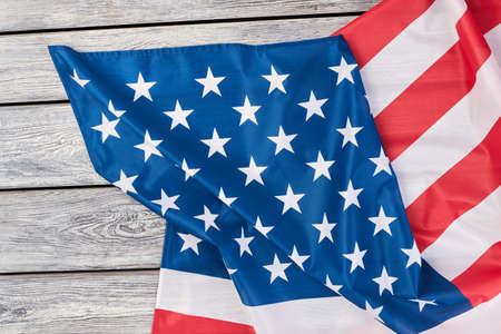 Flag of America on wooden background, top view. USA patriotic flag on a weathered wood background with copy space for message.の写真素材