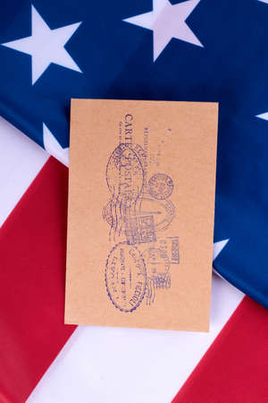 American flag and craft envelope with postmarks. American flag background. Vintage style envelope with documents.の写真素材
