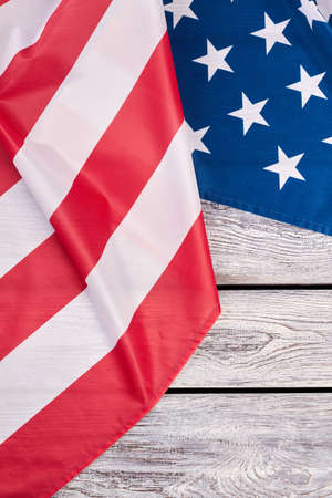 Patriotic flag of United States of America. USA flag placed on wooden background with copyspace, top...