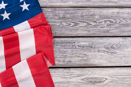 Border from American flag, horizontal image. United States of America flag draped as a border with a old wooden background and copy space.の写真素材