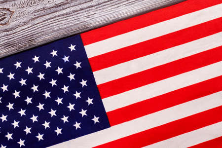 Close up flag of USA on wooden background. Cotton flag of United States of America on grey wood.の写真素材