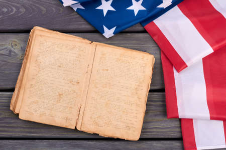 USA flag and old opened book. Constitution of United States of America. USA flag and Bible. America and religion.の写真素材