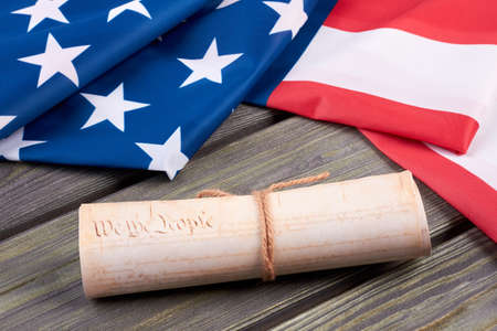 Declaration of the Independence of the United States. Close up vintage constitution of the USA and USA flag on wooden background. Documents of the country.の写真素材