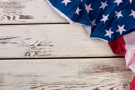 White wooden background with American flag. USA patriotic flag and copy space. Happy Veterans Day.の写真素材
