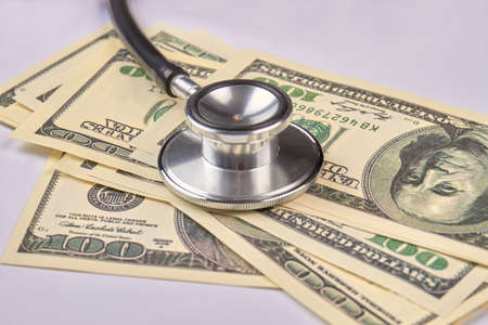 US dollars and stethoscope. Close up. Dollar banknotes.の写真素材