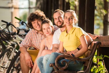 Young happy people resting outdoors. Four cheerful friends on summer vacation. People and summer concept.の写真素材